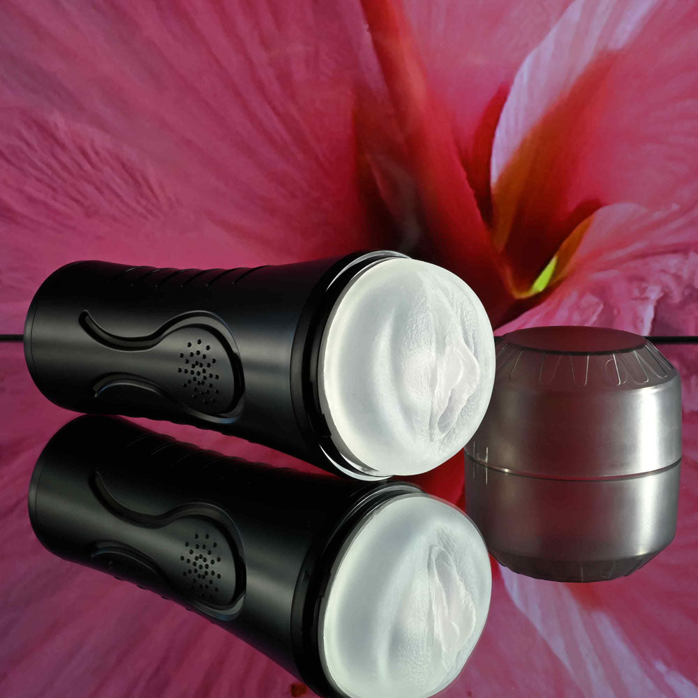 Zero Tolerance HOLD TIGHT -  USB Rechargeable Vibrating Vagina Stroker on a reflective surface with a flower backdrop.